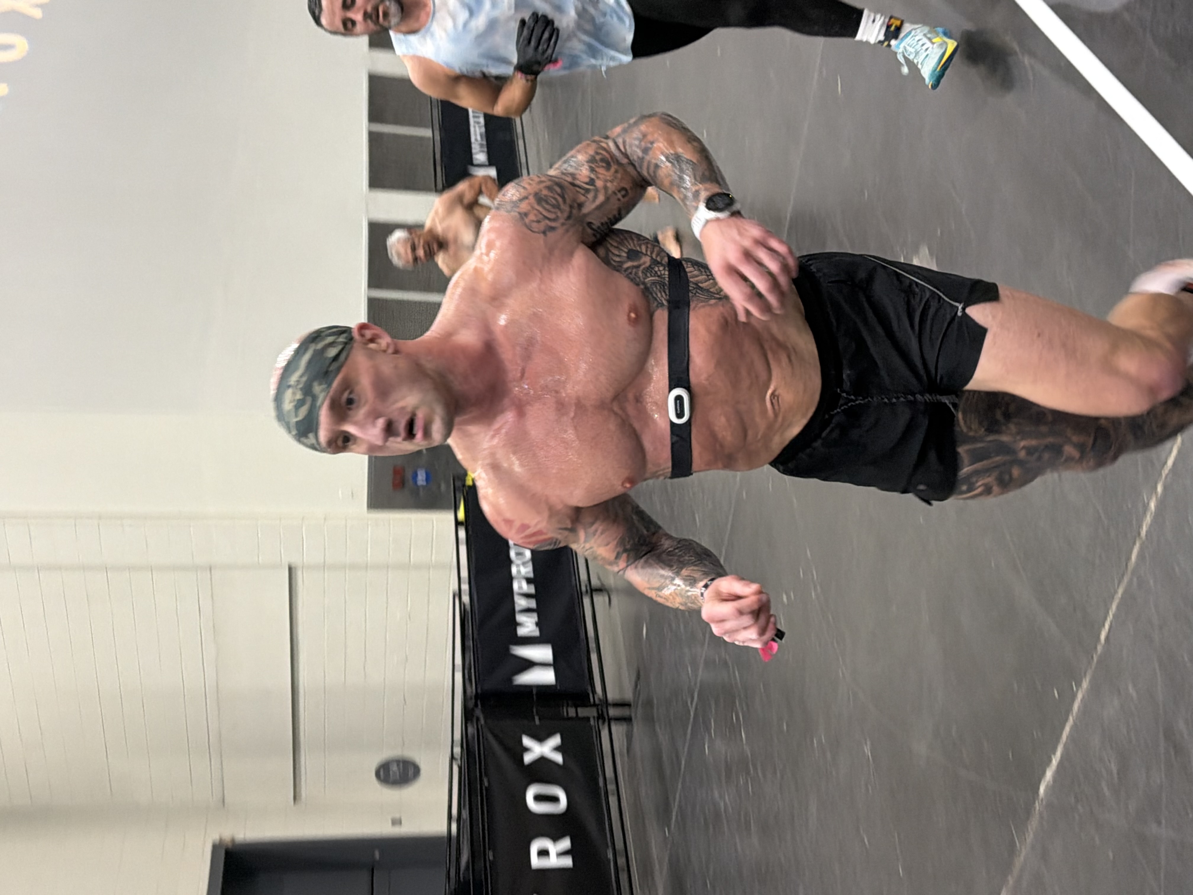 Tattooed athlete competing at a HYROX race event